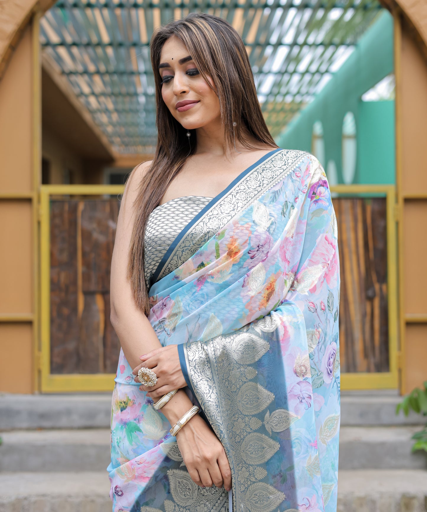 Pure Georgette Powder-Blue saree in Digital-Print with Dark-Blue Heavy Zari Border and Tassels paired with Blouse