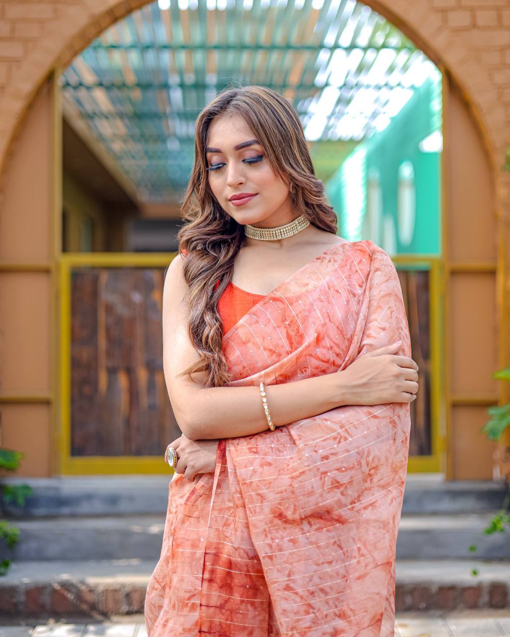 Soft-Orange Pure Organza-Silk saree with all over Zari Sequins and Tassels paired with Blouse