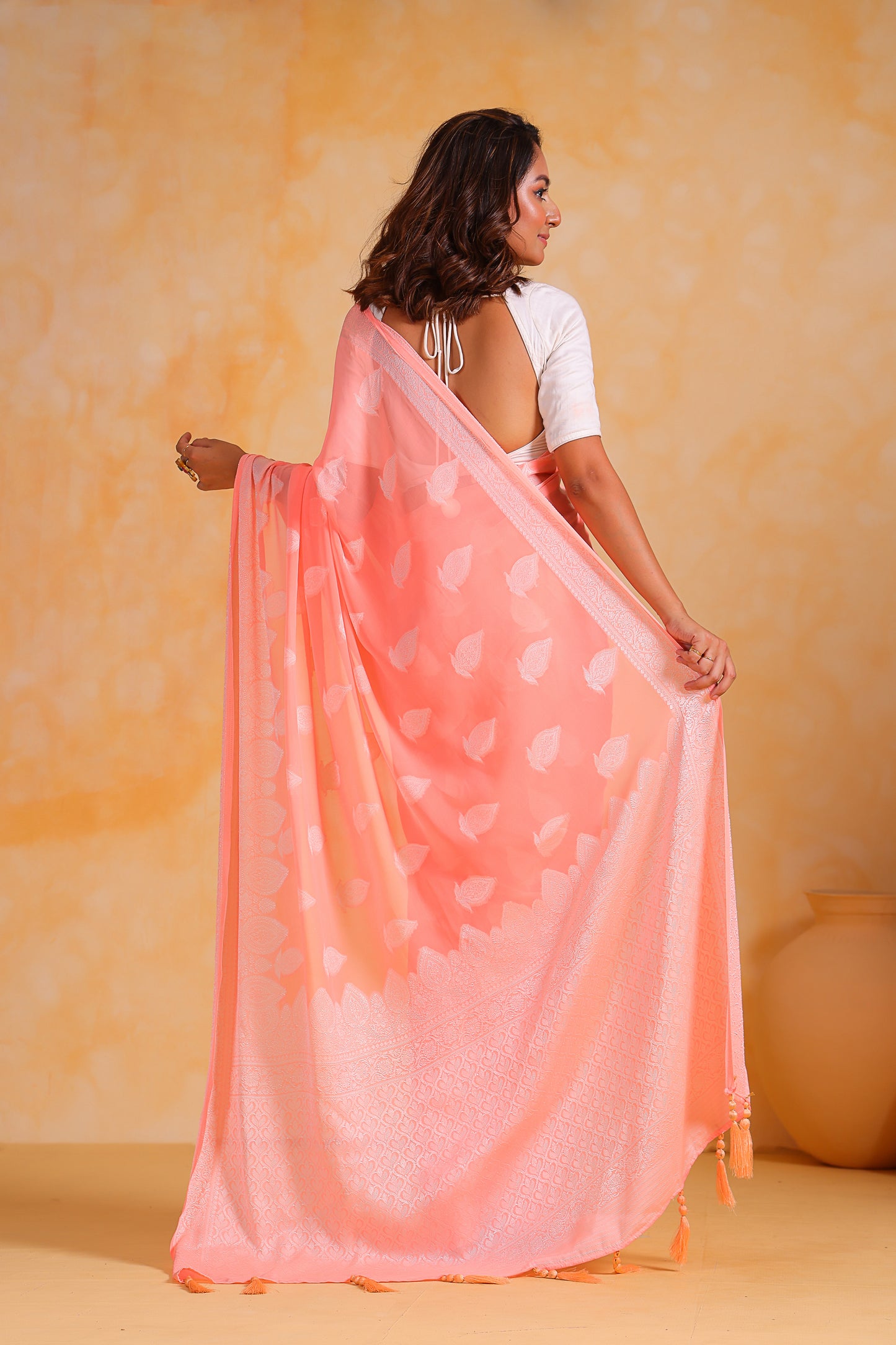 Hand-Woven Peach Pure Georgette-Silk Saree with Tassels and Heavy Blouse
