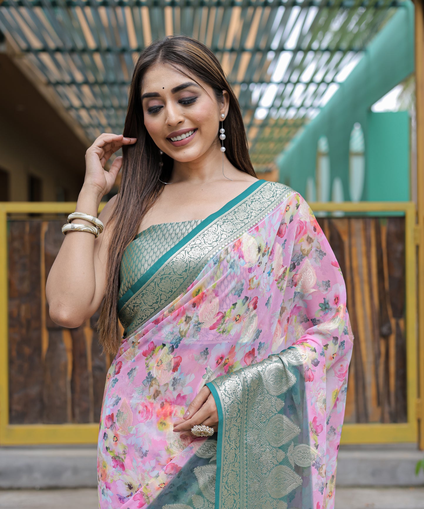 Pure Georgette Light-Pink saree in Digital-Print with Teal Heavy Zari Border and Tassels paired with Blouse