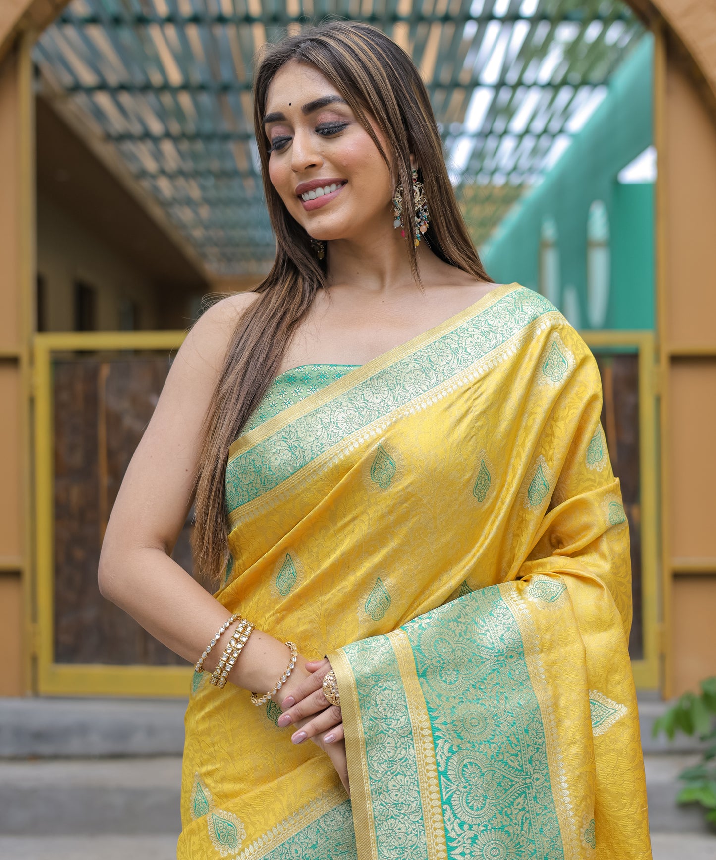 Heavy Embroidered Bright-Yellow saree with Sea-Green Zari Border paired with Blouse